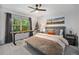 Cozy bedroom with a view, featuring natural light, neutral decor, and stylish furnishings at 12951 Vallejo Cir, Denver, CO 80234
