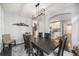 Stylish dining room with a large table, mountain decor, and open access to the kitchen at 12951 Vallejo Cir, Denver, CO 80234