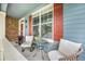 Relaxing front porch features cozy seating and an inviting view, perfect for morning coffee at 12951 Vallejo Cir, Denver, CO 80234