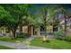 Well-kept front yard featuring a home with stone accents and a welcoming front porch at 12951 Vallejo Cir, Denver, CO 80234
