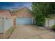 Attached two car garage with stone facade and a light blue garage door at 12951 Vallejo Cir, Denver, CO 80234