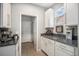 Charming kitchen nook boasting granite countertops, a wine rack, and space for a coffee bar at 12951 Vallejo Cir, Denver, CO 80234