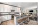 Open concept kitchen featuring stainless steel appliances, dark countertops, and seamless flow into the living area at 12951 Vallejo Cir, Denver, CO 80234