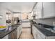 Spacious kitchen showcasing ample cabinet space, stainless steel appliances, and beautiful granite countertops at 12951 Vallejo Cir, Denver, CO 80234