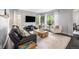 Bright living room showcasing a stylish seating arrangement and a large window at 12951 Vallejo Cir, Denver, CO 80234