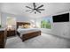 Inviting main bedroom featuring a dark wood bed frame, ceiling fan, and bright windows at 12951 Vallejo Cir, Denver, CO 80234