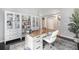 Stylish home office with built-in bookshelves, modern desk, and comfortable seating at 12951 Vallejo Cir, Denver, CO 80234