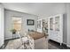 Bright home office featuring large windows, stylish desk, and built-in bookshelves at 12951 Vallejo Cir, Denver, CO 80234