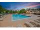 Community pool and lounge area with many lounge chairs surrounding the large pool on a sunny day at 12951 Vallejo Cir, Denver, CO 80234