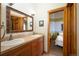 Bathroom features a double vanity with warm wood cabinets offering ample storage and counter space, enhancing functionality at 469 Elati St, Denver, CO 80204