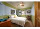 Bright bedroom with large window, ceiling fan, and wood trim, offering a tranquil space for relaxation and rest at 469 Elati St, Denver, CO 80204
