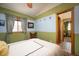 Inviting bedroom features a ceiling fan and a natural wood trim window offering a serene and comfortable ambiance at 469 Elati St, Denver, CO 80204