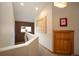 Bright hallway with carpet, a half-wall, and artwork, providing an elegant transition space within the home at 469 Elati St, Denver, CO 80204