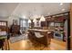 This kitchen features wooden cabinets, stainless steel appliances, and an island with bar seating at 469 Elati St, Denver, CO 80204