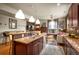 Open kitchen view features dark wood cabinets, stainless steel appliances, and a convenient breakfast bar at 469 Elati St, Denver, CO 80204
