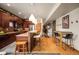 A warm kitchen that has wooden cabinets, stainless steel appliances, and stylish pendant lighting at 469 Elati St, Denver, CO 80204