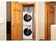 Efficient laundry area with stacked washer and dryer, maximizing space in a dedicated and functional room at 469 Elati St, Denver, CO 80204