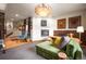 Spacious living room with a fireplace, plush seating, and unique art, perfect for entertaining guests at 469 Elati St, Denver, CO 80204