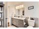 A stylish bathroom features a dual sink vanity, modern lighting, and tiled walls at 2034 S Idalia St, Aurora, CO 80013