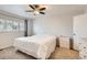 A well-lit bedroom features neutral walls, carpet, a ceiling fan, and built-in drawer units at 2034 S Idalia St, Aurora, CO 80013