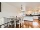 An open floor plan dining room features a modern chandelier, hardwood floors and white trim details at 2034 S Idalia St, Aurora, CO 80013