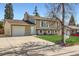 View of home with attached garage and well-maintained lawn at 2034 S Idalia St, Aurora, CO 80013