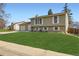 Well-maintained front yard of a two-story home with lush green lawn at 2034 S Idalia St, Aurora, CO 80013