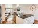 Open kitchen view with stainless appliances, island, and living area at 2034 S Idalia St, Aurora, CO 80013