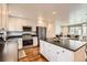 Open concept kitchen showcases stainless steel appliances and island at 2034 S Idalia St, Aurora, CO 80013