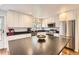 Modern kitchen featuring stainless steel appliances and center island at 2034 S Idalia St, Aurora, CO 80013