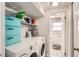 Laundry room featuring a washer, dryer, storage shelves, and a glimpse into the bathroom at 2034 S Idalia St, Aurora, CO 80013