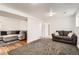 A spacious living room features a comfortable sectional sofa, hardwood floors and large area rug at 2034 S Idalia St, Aurora, CO 80013