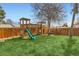 Backyard featuring a wooden play set with a slide, swing, and other play structures at 2034 S Idalia St, Aurora, CO 80013