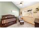 Charming Bedroom with a dark wood crib, a ceiling fan, and mountain views from the window at 10180 Blue Sky Trl, Conifer, CO 80433