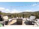 Outdoor deck featuring comfortable seating, a modern fire pit, and scenic mountain views at 10180 Blue Sky Trl, Conifer, CO 80433