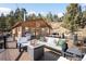 Outdoor deck featuring comfortable seating, a fire pit, and scenic views at 10180 Blue Sky Trl, Conifer, CO 80433