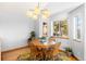 Bright dining room with a round wooden table, decorative rug, and modern lighting at 10180 Blue Sky Trl, Conifer, CO 80433