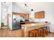 Bright kitchen with stainless steel appliances, light wood cabinets, and breakfast bar at 10180 Blue Sky Trl, Conifer, CO 80433