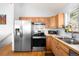 Well-lit kitchen with stainless steel appliances and light wood cabinetry at 10180 Blue Sky Trl, Conifer, CO 80433