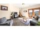 Bright living room with hardwood-framed doors to the balcony and mountain views at 10180 Blue Sky Trl, Conifer, CO 80433