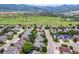 Aerial view capturing the neighborhood's tree-lined streets and the home's location near mountain landscapes at 10614 Kicking Horse Dr, Littleton, CO 80125
