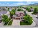 Aerial view of home features a large driveway, three-car garage, and beautifully landscaped front yard at 10614 Kicking Horse Dr, Littleton, CO 80125