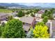 Beautiful aerial view of the home, lush green trees, and neighborhood at 10614 Kicking Horse Dr, Littleton, CO 80125
