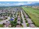 Expansive aerial view of a neighborhood nestled near a green space, providing a serene and picturesque environment at 10614 Kicking Horse Dr, Littleton, CO 80125