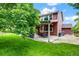 Spacious backyard with a covered patio and lush green lawn is perfect for relaxing or entertaining at 10614 Kicking Horse Dr, Littleton, CO 80125
