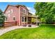 Inviting backyard features a cozy patio, fire pit, green lawn, and mature trees at 10614 Kicking Horse Dr, Littleton, CO 80125
