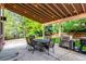 Backyard patio area with a dining table, grill, and a view of the landscaped yard at 10614 Kicking Horse Dr, Littleton, CO 80125