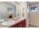 Bright bathroom featuring double sinks, neutral tones, and ample counter space at 10614 Kicking Horse Dr, Littleton, CO 80125