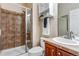 Bathroom features a tiled walk-in shower, toilet, and sink with wooden cabinets at 10614 Kicking Horse Dr, Littleton, CO 80125