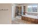 Large bathroom includes a shower, soaking tub and tiled floors at 10614 Kicking Horse Dr, Littleton, CO 80125